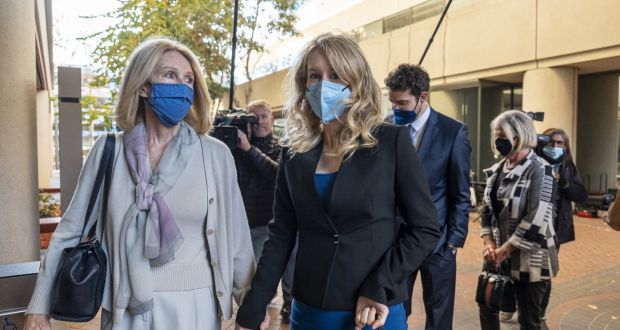 Elizabeth Holmes, right,  arrives at federal court in San Jose, California on Tuesday. She faces fraud and conspiracy charges over her claims Theranos had revolutionised blood testing technology. Photograph: David Paul Morris/Bloomberg