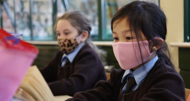 At school gates, parents had to ensure children, aged nine and upwards, had their masks on properly before they headed into classrooms. Photograph: Bryan O Brien/The Irish Times