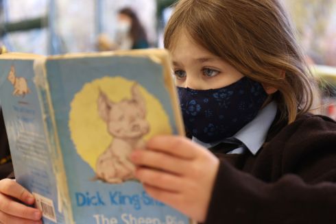 HEAD IN A BOOK: A pupil from St Clare’s Primary School in Harold’s Cross, Dublin, wearing a face mask in the classroom during lessons. From today new rules have come into effect requiring third-class students and above to wear face coverings in public, indoor settings. Photograph: Bryan O’Brien