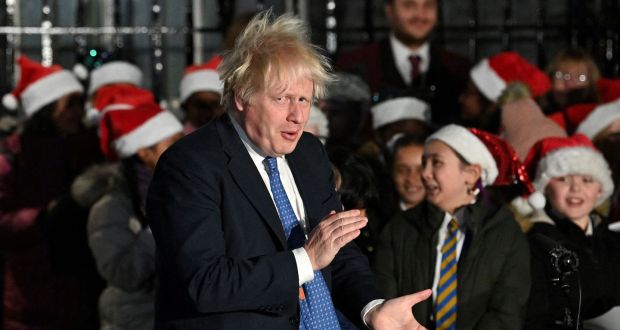 Britain’s prime minister Boris Johnson applauds the choir as he attends the switch on of the Christmas tree lights outside 10 Downing Street in London on December 1, 2021. Photograph:  Justin Tallis/AFP via Getty Images
