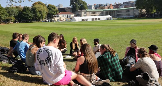 Students at Trinity College Dublin relax in the early-September sunshine.  Ireland experienced  a particularly warm autumn this year. Photograph: Dara Mac Dónaill