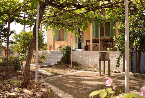 This Greek village house has gardens filled with peaches, oranges, cherries and figs