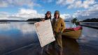 Renato Mela and Colum Stapleton with a newly created page of the annals on Doon Shore, Lough Key.  Photograph: Brian Farrell