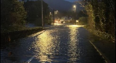 The N71 road near the suspension bridge in Kenmare was flooded and impassable. Image: Twitter/Kerry Co Council