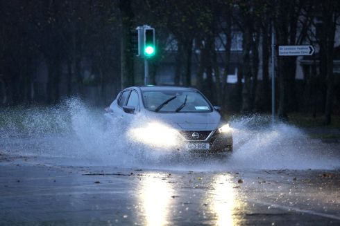 A car drives through floodwater in Clontarf, Dublin, this morning. Photograph: Dara Mac Donaill/The Irish Times