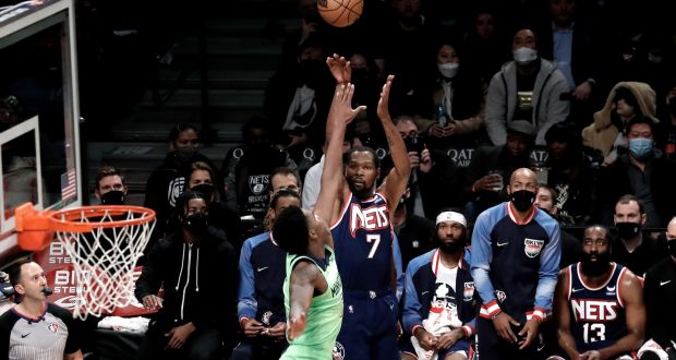 Brooklyn Nets forward Kevin Durant shoots over Minnesota Timberwolves forward Josh Okogie. Photograph: Peter Foley/EPA
