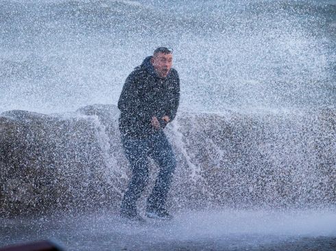 BE MY GUEST: Martin Cassidy, from Lisnaskea, Co Fermanagh, gets a cold soaking by a bullish wave at Coliemore Harbour, Dalkey, Co Dublin. Photograph: Tom Honan