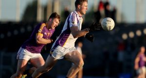 Kilmacud Crokes’ Paul Mannion is chased by Daniel O’Neill of Wolfe Tones during the AIB Leinster Club SFC quarter-final  at Páirc Tailteann in  Navan. Photograph: Tom Maher/Inpho