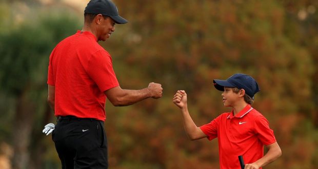 Tiger Woods fist bumps his son Charlie on the 18th hole during the final round of the PNC Championship at the Ritz-Carlton Golf Club  in Orlando in December 2020. Photograph: Mike Ehrmann/Getty Images