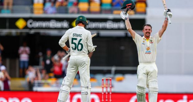 Travis Head celebrates his century with teammate Mitchell Starc during day two of the first Ashes Test match. Photo: Patrick Hamilton/Getty Images