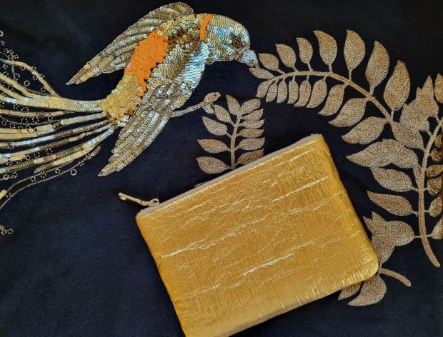 Gold faux leather clutch â‚¬ 85 with embroidered cashmere scarf â‚¬ 295, both from Susannagh Grogan
