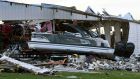 A boat sits at rest after being sucked out of a marine dealership by a tornado in Mayfield, Kentucky. Photograph: John Amis / AFP/ Getty Images