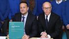 Former taoiseach Leo Varadkar and businessman David McCourt sign the National Broadband contract in November 2019 at St Kevin’s National School in Co Wicklow. Photograph: Niall Carson/ PA Wire
