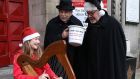 Emily Breslin, a student at Alexandra College plays the harp as Fred Dean and Terry Lilburn from St Ann’s Church on Dawson Street launch their 2021 annual Black Santa Appeal for charities in Dublin. Photograph: Damien Eagers for The Irish Times