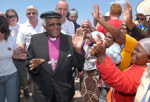 Niall Mellon follows Archbishop Emiritus Desmond Tutu on his arrival at the official launch and welcome of the 2006 Nial Mellon Township Initiative. More than 700 homes are being built in Mfuleni near Cape Town by Irish volunteers as part of the Niall Mellon Township Initiative. Picture Rogan Ward.

