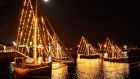 FULL MOON: Hooker sails shine bright with Christmas lights while moored for the night in the Claddagh, Galway, under a full moon on Christmas Eve. Photograph: Clodagh Kilcoyne

