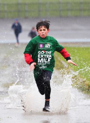BRAVE THE WEATHER: Luca McLaughlin (11) takes part in the annual GOAL Mile, in Eamonn Ceannt Park, Crumlin, Co Dublin. Photograph: Leon Farrell/Photocall Ireland
