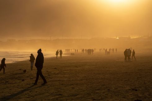 GOLDEN HOUR: People take a St Stephen's Day stroll on the beach in Clogherhead, Co Louth.
