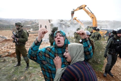 LAND DISPUTE: Palestinian women react as their house, still under construction, is demolished in the West Bank city of Hebron. According to Israeli authorities, it had been built without obtaining necessary permits. Photograph: Abed al Hashlamoun/EPA