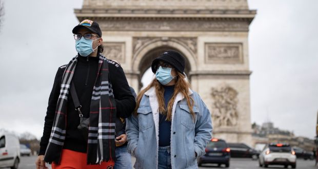 Pedestrians  walk on the Champs-Élysées in central Paris. France set a new record for daily cases in Europe by confirming 208,000 cases in 24 hours on Wednesday, followed by 206,000 on Thursday. Photograph: Ian Langsdon/EPA