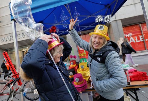 Veronica Perry and Talina Hendrick selling happy new year hats from their stall on Dublin#s Henry Street.  Photograph: Alan Betson/The Irish Times


