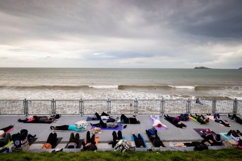 SOOTHING SEA SOUNDS: A group of people practise yoga with Mind Yourself Yoga amid ongoing mild weather, at Portmarnock Beach, Co Dublin. Photograph: Tom Honan
