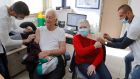 An Israeli couple receive their fourth dose of the Pfizer-BioNTech  vaccine at a clinic   in Tel Aviv. Photograph: Jack Guez/AFP