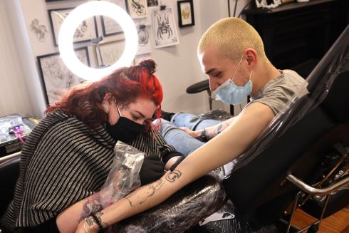 FRESH INK: Tattoo artist Clara Whyte (left) works on a piece for Dylan Byrne from Finglas at the Wildcat Ink Tattoo shop, Temple Bar, Dublin. Photograph: Dara Mac Dónaill/The Irish Times




