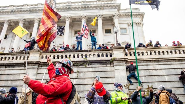 A mob allegedly incited by President Donald Trump storms the Senate side of the US Capitol in Washington DC last January. Photograph: Jason Andrew/The New York Times