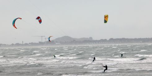 Kitesurfers enjoy the blustery conditions this morning at Dollymount Strand in Dublin. Photograph: Laura Hutton/The Irish Times
