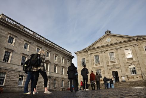 PANDEMIC PERSISTS: Students queue for Covid-19 vaccinations at Trinity College Dublin as universities and colleges reopen following the festive break. Photograph: Dara Mac Dónaill