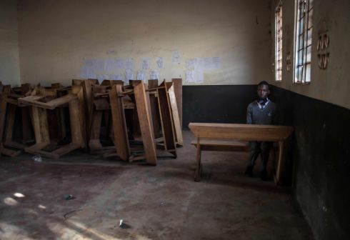 EMPTY DESKS: A student sits alone in a classroom after reporting to school on day one of reopening following an almost two-year closure of schools as part of government measures to curb the spread of Covid-19, in Kampala, Uganda. Health minister Dr Jane Ruth Aceng announced last week that the country is now battling the third wave of the pandemic. Photograph: Badru KAatumba/AFP/Getty
