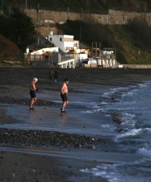 AT SWIM: People out for an early morning swim on Killiney Beach, Dublin. Photograph: Stephen Collins/Collins
