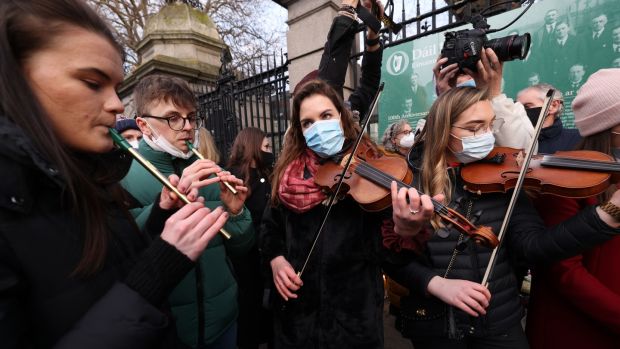 Musicians and friends of Ashling Murphy play at a vigil for the teacher outside Leinster House. Photograph: Laura Hutton/The Irish Times