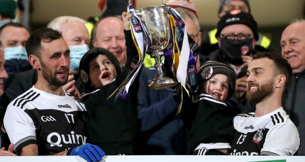 Kilcoo’s Aidan Branagan and Conor Laverty lift the trophy after their Ulster final win. Photograph: Bryan Keane/Inpho
