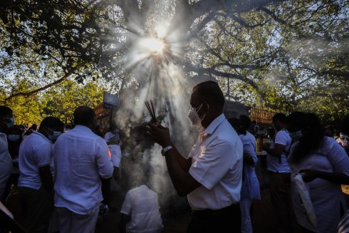 BUDDHIST RITES: Sri Lankan Buddhist devotees take part in a religious ceremony during the first full moon of the new year at a temple in the Kelaniya suburb of Colombo, Sri Lanka. Photograph: Chamila Karunarathne/EPA
