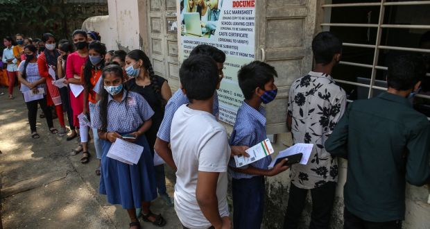  Indian students wait for their turn to get a Covid-19 vaccine shot at Chogle High School in Borivali, in Mumbai, on Monday. Photograph: Divyakant Solanki/ EPA