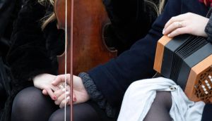 Trad musician friends of Ashling Murphy console each other  at her funeral. Photograph: Colin Keegan/Collins