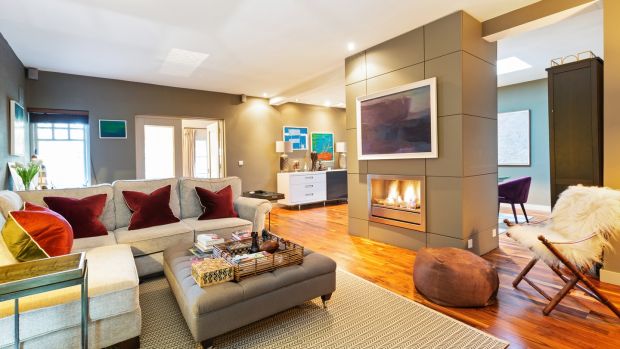 Family room with dual aspect gas fire in divider panel opening into dining room