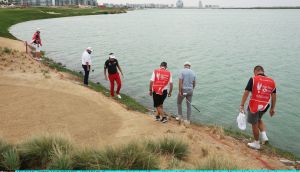  Shane Lowry  and Rasmus Hojgaard of  help Ian Poulter  look for his ball in the water on the 16th hole during the first round of the Abu Dhabi HSBC Championship at Yas Links Golf Course. Photograph: Andrew Redington/Getty Images