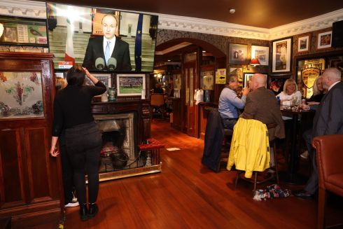 ‘TODAY IS A GOOD DAY': Customers in McGrattans pub on Fitzwilliam Lane in Dublin watch as Taoiseach Micheál Martin gives his address to the nation announcing the lifting of almost all Covid-19 restrictions. Photograph: Laura Hutton