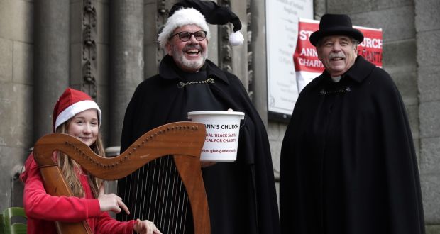 Emily Breslin, a student at Alexandra College plays the harp as Fred Dean and Terry Lilburn from St Anns Church on Dawson Street launch their 2021 annual Black Santa Appeal for charities in Dublin. Photograph: Damien Eagers for The Irish Times