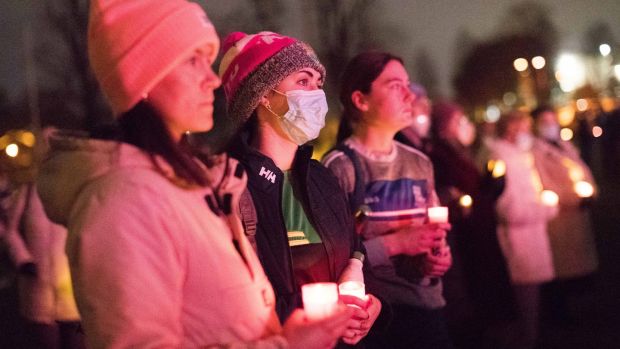 People hold up candles at a vigil for Ashling Murphy at Mary Immaculate College, Limerick, on Monday evening. Photograph: Eamon Ward