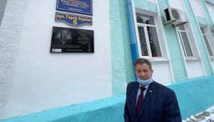 Mykhailo Kuprikov, director of the Kramatorsk vocational college in eastern Ukraine, stands beside a memorial plaque to Yevhen Pahulich (19), a former student killed fighting Russian-led separatists in 2015. Photograph: Daniel McLaughlin