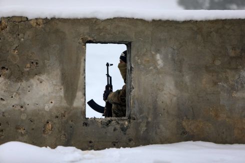 AROUND THE WORLD: A Turkey-backed Syrian fighter during a military training at a snow-covered base in the Afrin region. Photograph: Bakr Alkasem/AFP via Getty