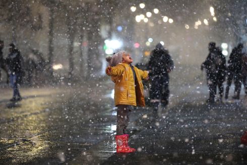 SNOWSTORM: A toddler embraces the snow in Jerusalem, Israel, during Storm Elpis, which has also affected Turkey and Greece. Photograph: Abir Sultan/EPA