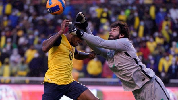 Ecuador’s Ayrton Preciadois punched by Brazil goalkeeper Alisson. Photograph: Santiago Arcos/EPA
