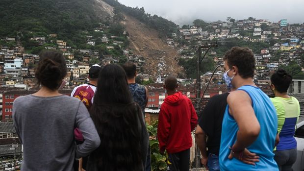 Residents observe a damaged hillside after heavy rains caused landslides in Petrópolis, Rio de Janeiro state, Brazil. Photograph: Andre Borges/Bloomberg