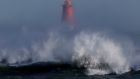  Waves breaking on the shoreline in front of the Poolbeg lighthouse in Dublin as Storm Eunice brings gale force winds across the country. Photograph: Alan Betson / The Irish Times