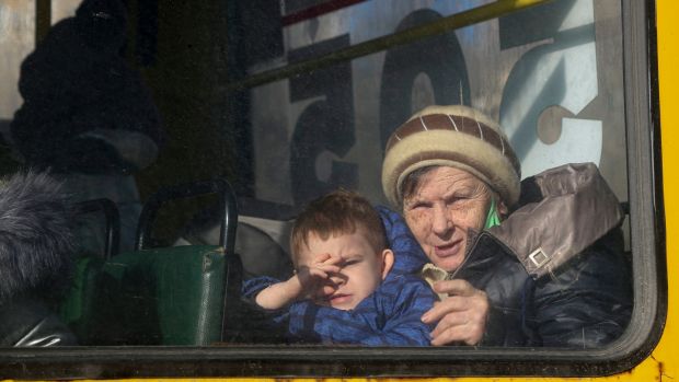 An elderly woman and a boy look through a bus window, waiting to be evacuated to Russia, in Donetsk, the territory controlled by pro-Russian militants, eastern Ukraine on Saturday. Photograph: Alexei Alexandrov/AP